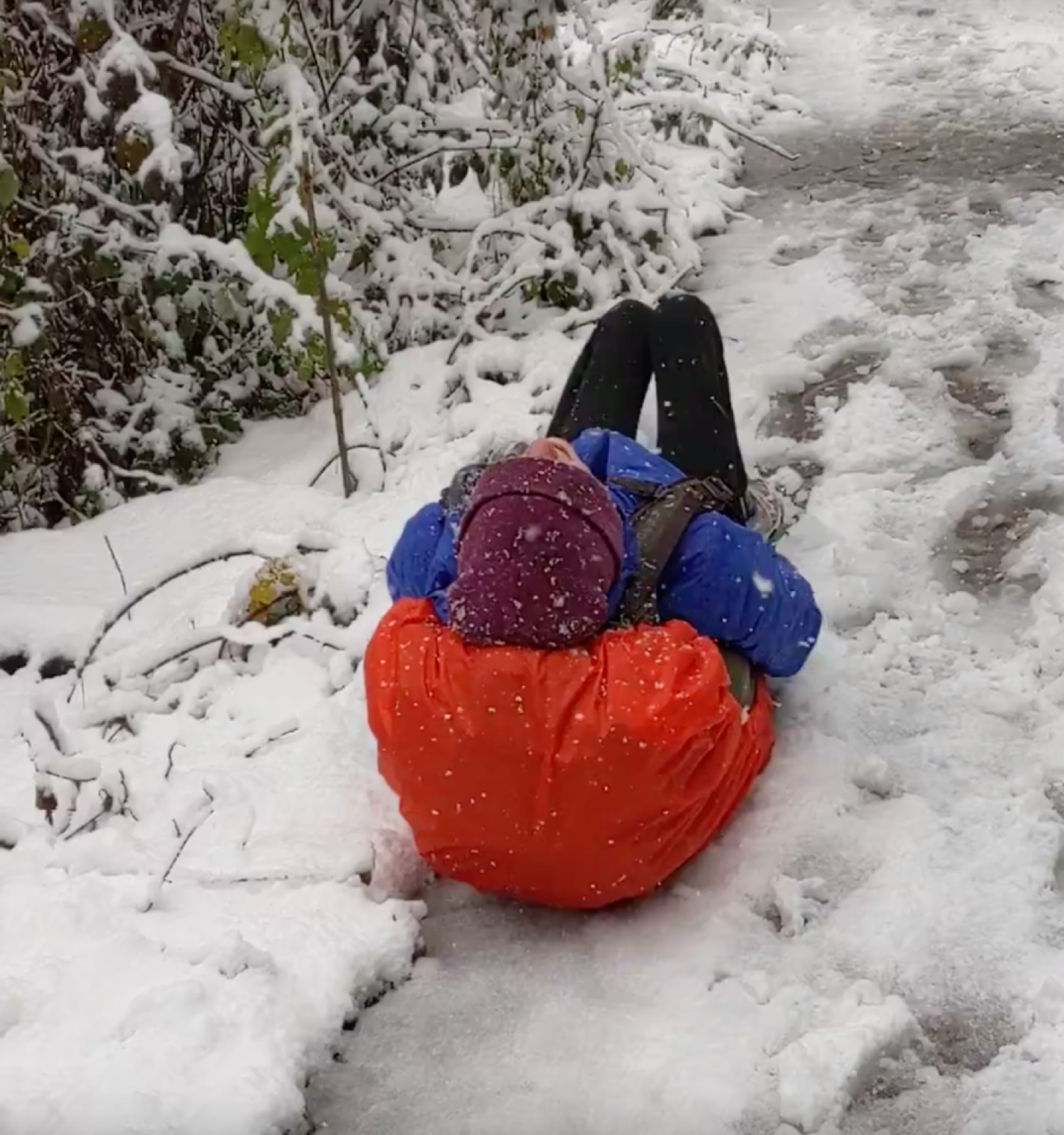 Person stuck on their back, with a big backpack on